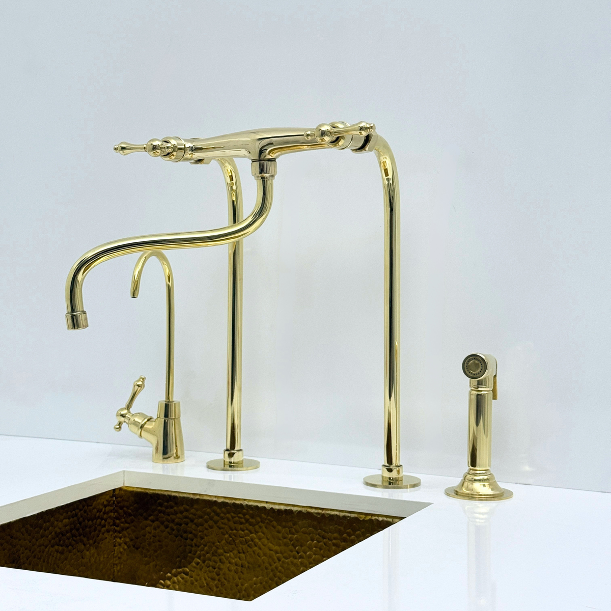 Unlacquered brass kitchen faucet with sprayer and drinking water tap — front view