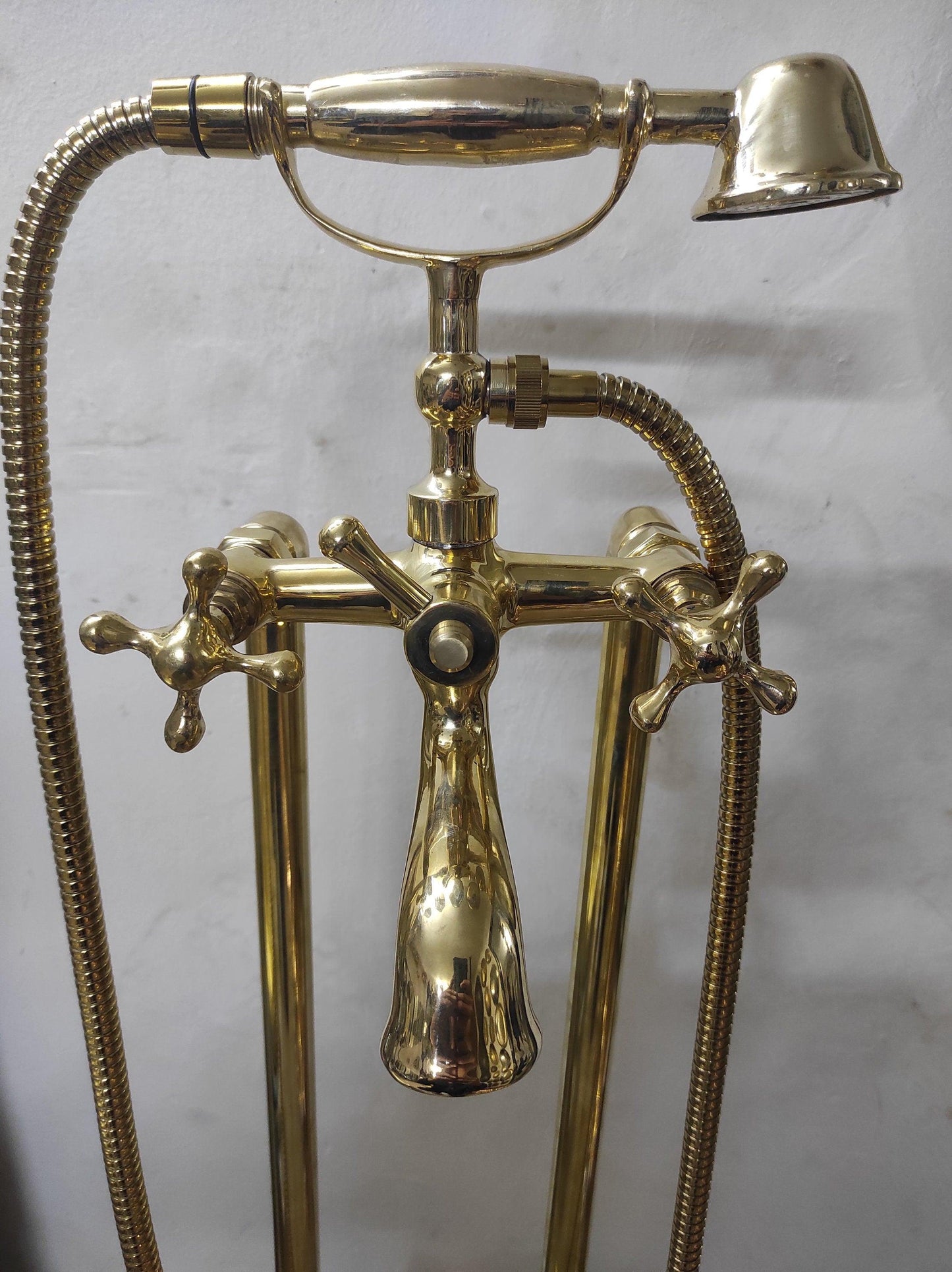 Hand-held, unlacquered brass faucet with solid brass freestanding tub filler