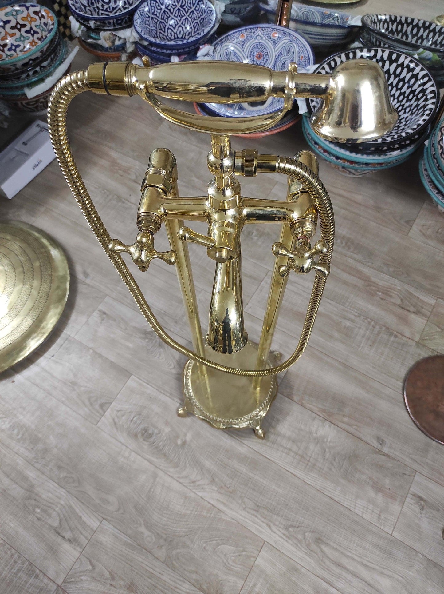 Hand-held, unlacquered brass faucet with solid brass freestanding tub filler