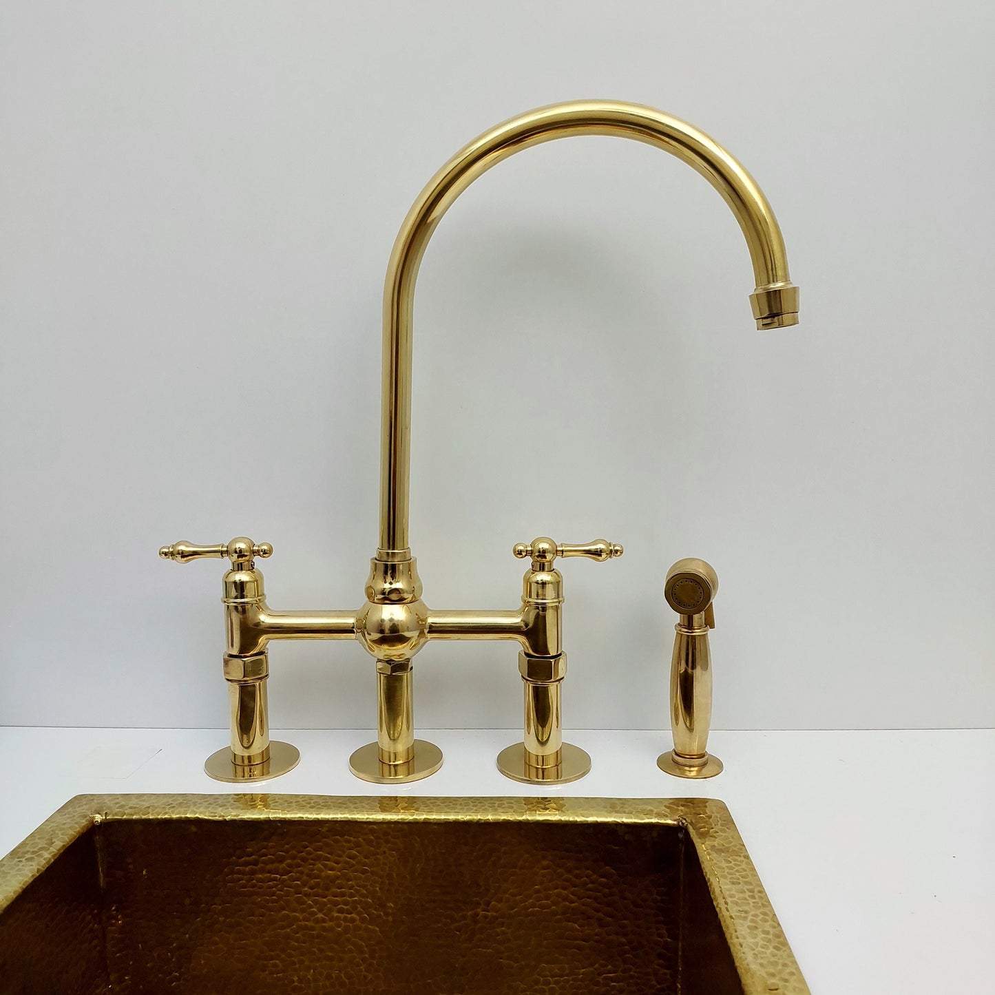 Unlacquered Brass Bridge Kitchen Faucet With Ball Center, 3 Straight Legs, And Sprayer - 8" Spread - Ref: AKC-4